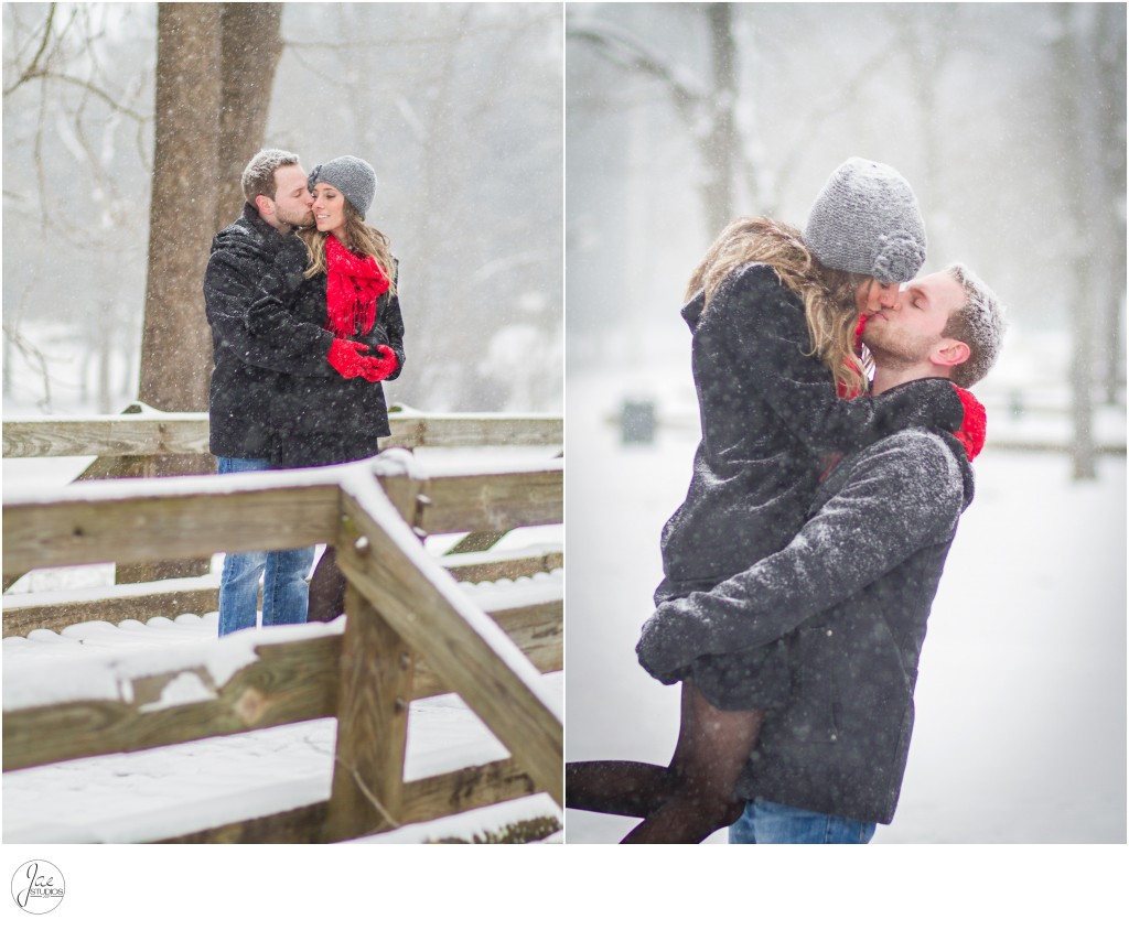 Kaleigh and Austin, Lynchburg Mini Winter Engagement Session, Kissing, Gray Hat, Red Scarf, Red Gloves, Jeans, Black Jacket, Wood Bridge, Snow, Hugging, Picking her up