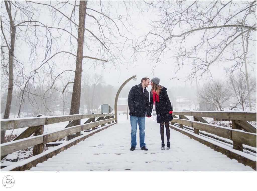 Kaleigh and Austin, Lynchburg Mini Winter Engagement Session, Wood Bridge, Street Lamp, Holding Hands, Gray Hat, Jeans, Black Jacket, Red Gloves, Red Scarf, Snow