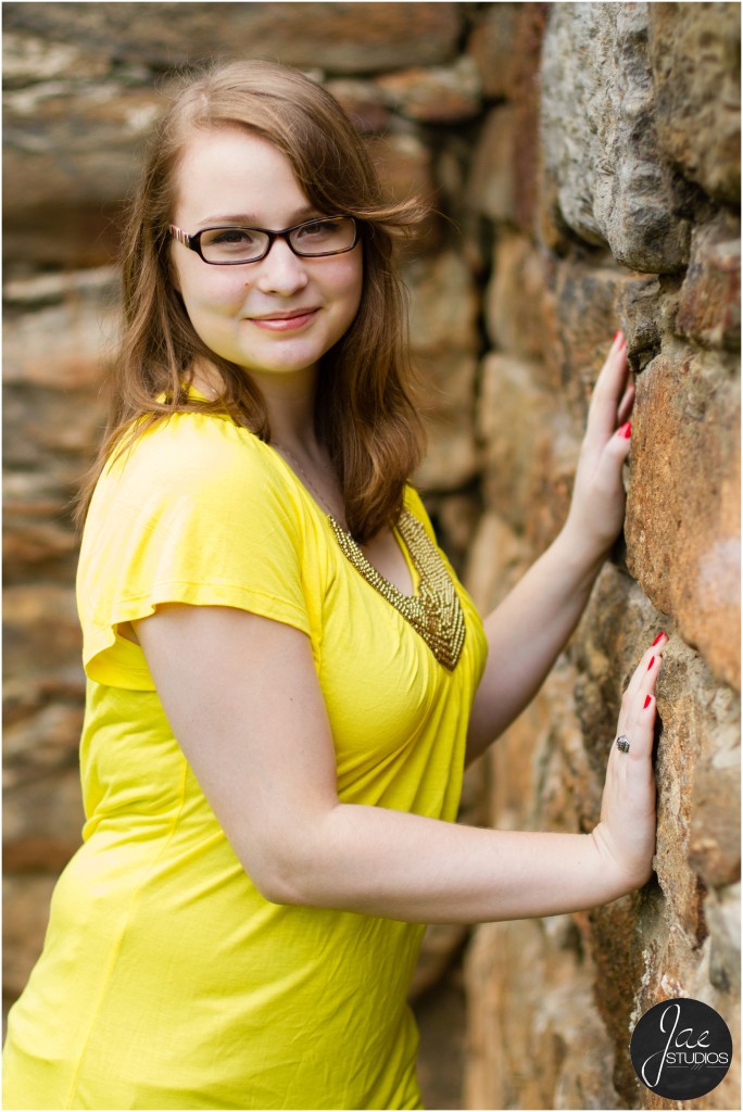 Lynchburg Senior Girl Emily 2014. She is facing the wall as her hands rest against it.