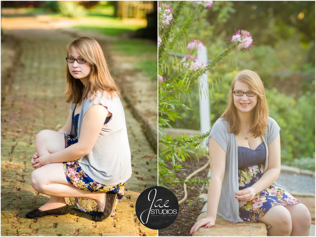 Lynchburg Senior Girl Emily 2014. She is crouched on the cobblestone path in a blue flowered dress and gray cardigan. Then, she is sitting on a stone bench in front of pink flowers while looking to the side.
