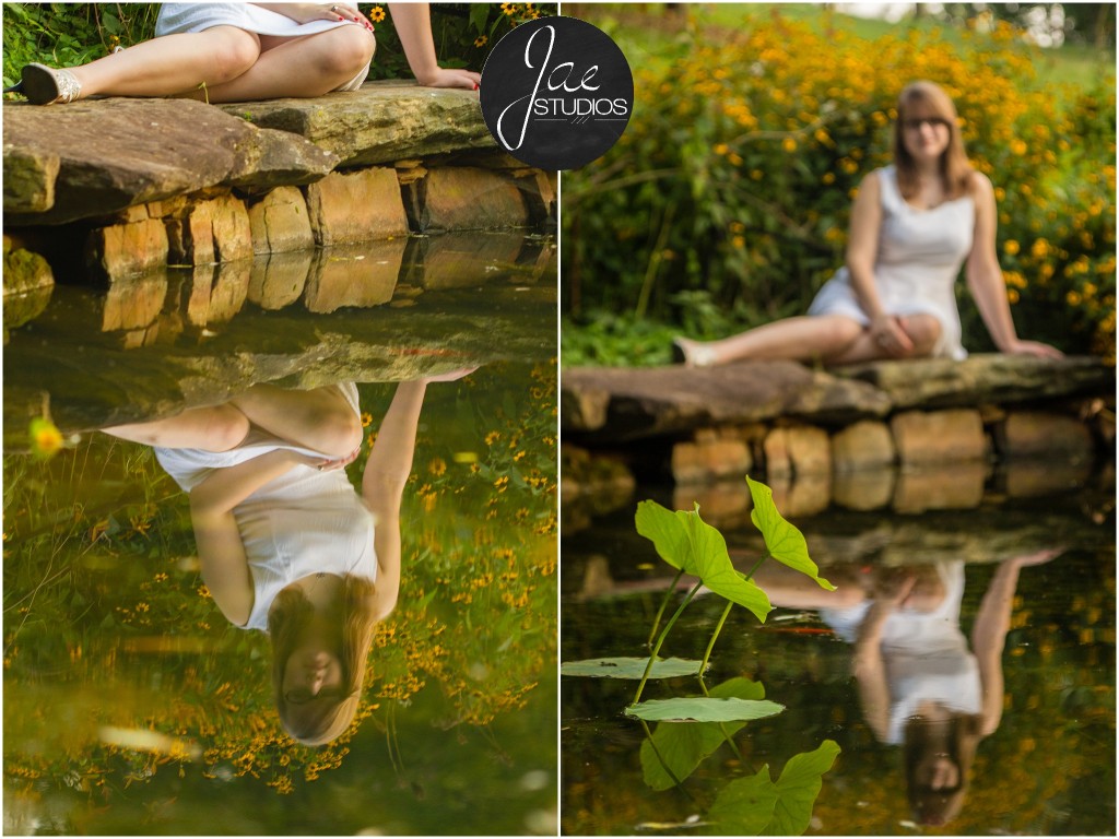Lynchburg Senior Girl Emily 2014. She is resting by a small pond as her reflection can be seen in the water while lily pads float at the bottom of the picture.