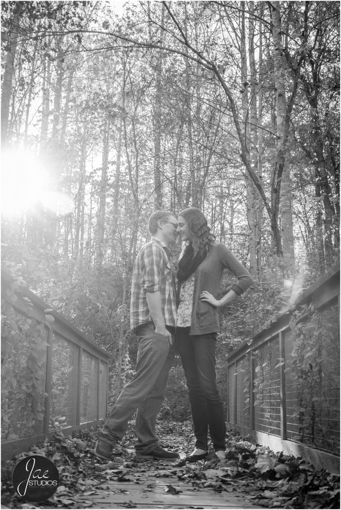 Lynchburg Engagement Patrick and Rebecca. A low shot of a quick peck between the couple on a rustic background.