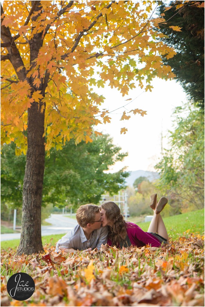 Lynchburg Engagement Patrick and Rebecca. Lying in the yellow and brown leaves while they exchanged a kiss and snuggled close to each other.
